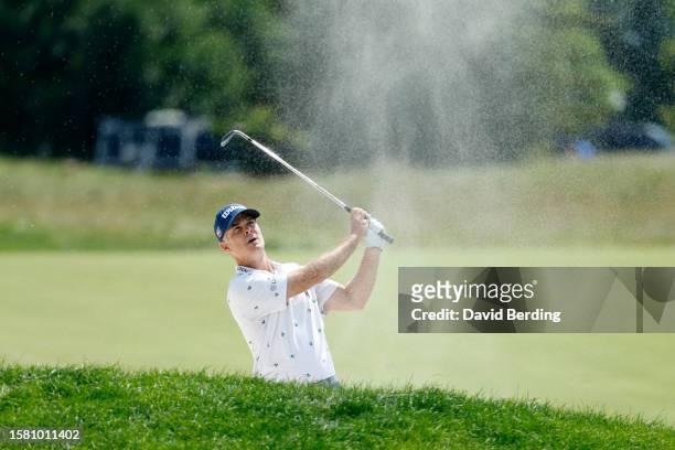 Kevin Streelman of the United States plays a shot from a bunker on the first hole during the final round of the 3M Open at TPC Twin Cities on July...