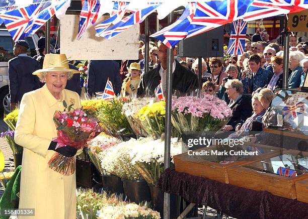 The Queen Visits Enfield Market In London. .