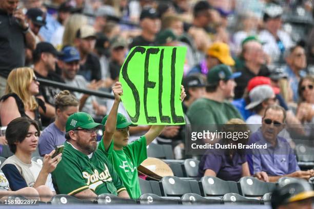 An Oakland Athletics fan holds a sign that reads sell during a game between the Colorado Rockies and the Oakland Athletics at Coors Field on July 29,...