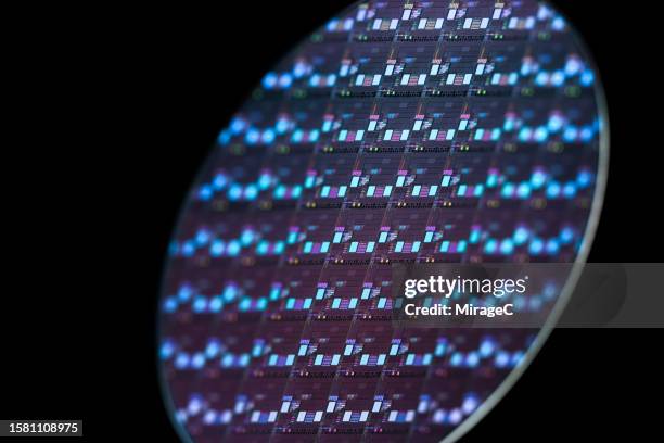 blue semiconductor wafer on black background - wafeltje stockfoto's en -beelden