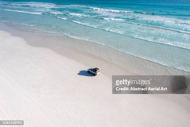 aerial image showing a 4x4 driving across cape le grand beach, esperance, western australia, australia - beach western australia bildbanksfoton och bilder