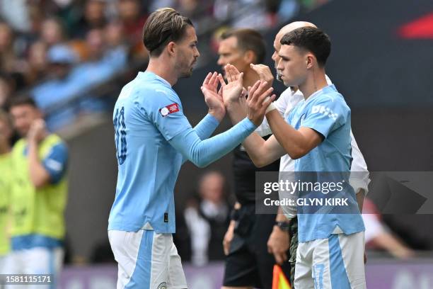 Manchester City's English midfielder Phil Foden replaces Manchester City's English midfielder Jack Grealish during the English FA Community Shield...
