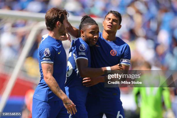 Christopher Nkunku of Chelsea celebrates with teammates Ben Chilwell and Thiago Silva after scoring the team's second goal during the Premier League...