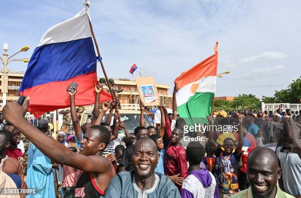 Supporters of Niger's National Council for the Safeguard of the Homeland wave Niger and Russian flags as they demonstrate in Niamey on August 6,...