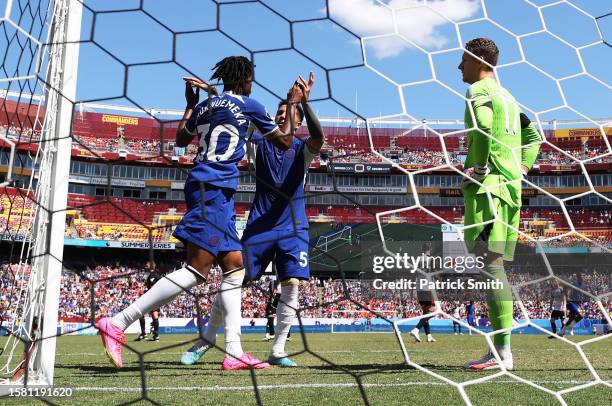 Carney Chukwuemeka and Enzo Fernandez of Chelsea celebrate after teammate Christopher Nkunku scored the team's second goal during the Premier League...