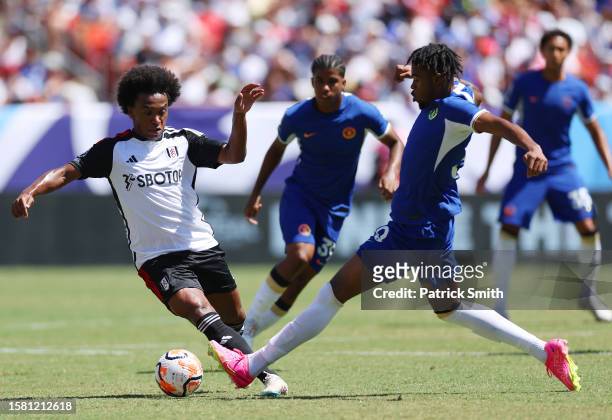 Willian of Fulham is challenged by Carney Chukwuemeka of Chelsea during the Premier League Summer Series match between Chelsea FC and Fulham FC at...