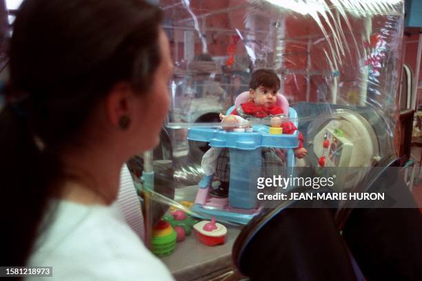 Nurse looks 21 February 1989 at Debrousse hospital in the central French city of Lyon at a child suffering from a severe, hereditary immune...