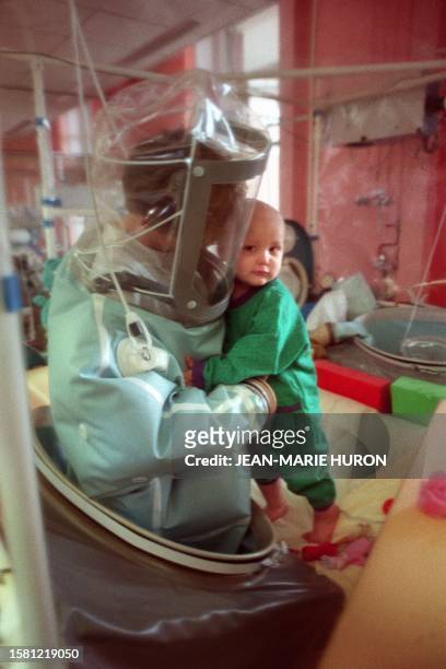 Nurse takes care 21 February 1989 at Debrousse hospital in the central French city of Lyon of a child suffering from a severe, hereditary immune...