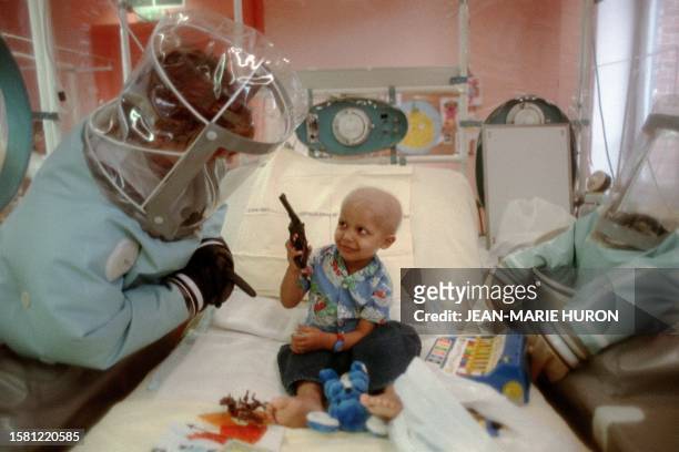 Nurse takes care 21 February 1989 at Debrousse hospital in the central French city of Lyon of a child suffering from a severe, hereditary immune...