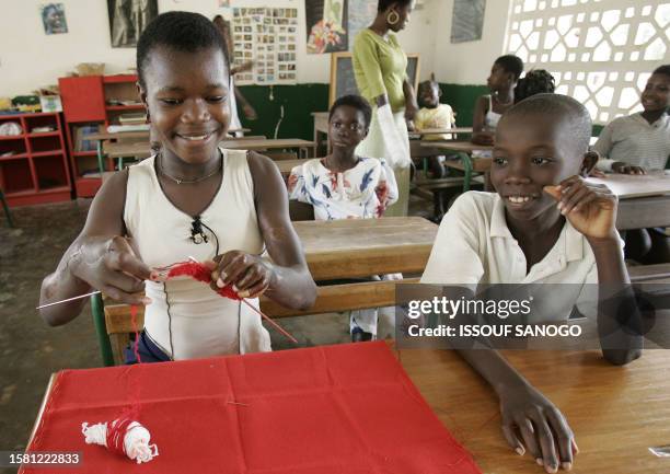 Children infected with leprosy of the Bruli ulcer, a skin disease closely related to leprosy, learn how to knit 24 January 2005 at the elemetary...