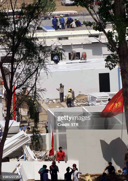 Hundreds of Chinese construction workers assemble the prefabricated buildings for a 1000-bed camp, at a site which will be used as an isolation camp...