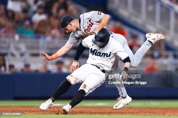 Zack Short of the Detroit Tigers and Jon Berti of the Miami Marlins collide during the sixth inning of the game at loanDepot park on July 30, 2023 in...