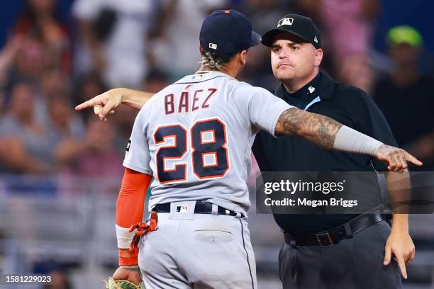 Javier Baez of the Detroit Tigers and umpire Jansen Visconti speak on the field during the sixth inning of the game against the Miami Marlins at...