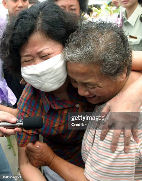 Recovered Severe Acute Respiratory Syndrome patient Hong Yu hugs a family member after being released from the Xiaotangshan SARS hospital in the...