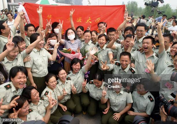 Chinese People's Liberation Army medical staff celebrate after the last batch of SARS patients were dischargered from the Xiaotangshan SARS hospital...