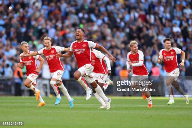 Arsenal' players celebrate after winning The FA Community Shield match between Manchester City against Arsenal at Wembley Stadium on August 6, 2023...