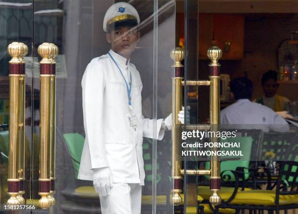 Thai doorman waits for clients at in front of a hotel in Bangkok, 19 May 2003. The Tourism Authority of Thailand has warned the Thai government that...