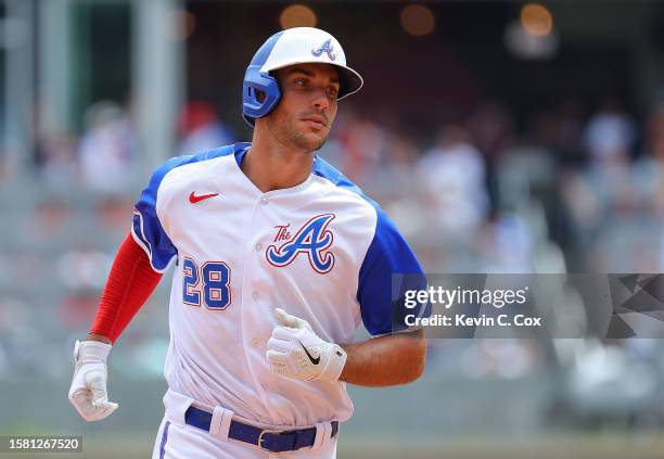 Matt Olson of the Atlanta Braves rounds second base after hitting a two-run homer in the eighth inning against the Milwaukee Brewers at Truist Park...