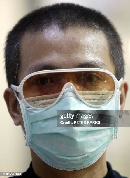 Man wears a mask with a fashionable pair of glasses to protect against a killer outbreak of pneumonia in Hong Kong 07 April 2003. Twenty two people...