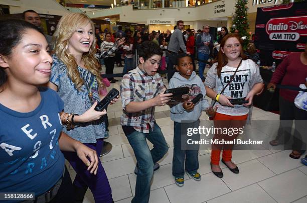 Olivia Holt and Cameron Boyce stars of Disney Channel’s hit series "Jessie" battle in the Wii U Showdown at Westfield Century City Mall in Los...