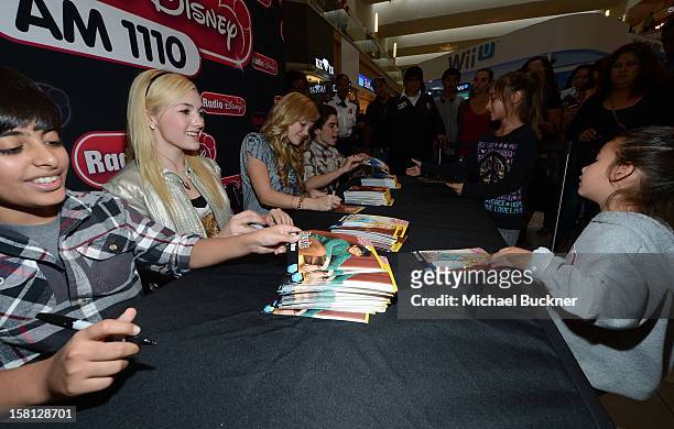 Karan Brar, Peyton List, Cameron Boyce and Olivia Holt stars of the hit series "Jessie" gets signs autographs for Radio Disney AM 1110 fans at the...