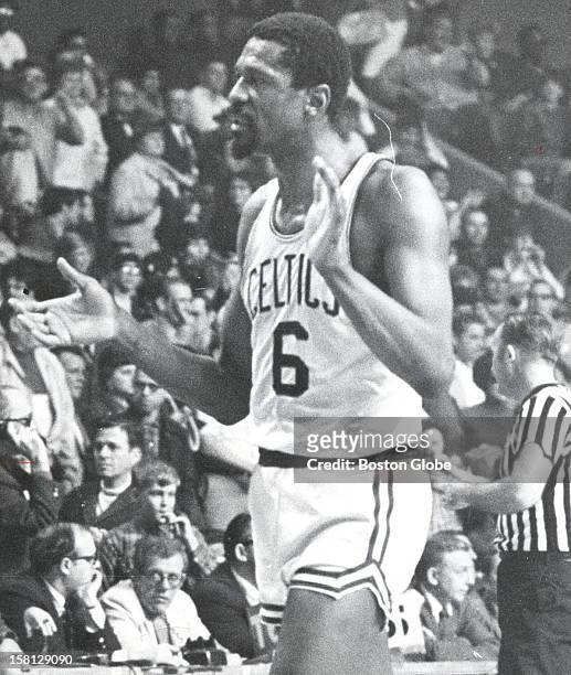 Boston Celtics player Bill Russell applauds his team's effort against the New York Knicks with two seconds left in the game, April 13, 1969.