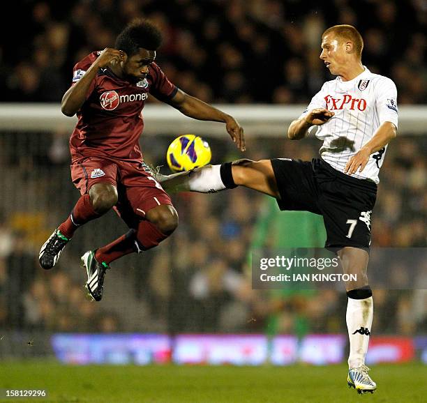 Newcastle United's Burundian midfielder Gael Bigirimana vies with Fulham's English midfielder Steve Sidwell during the English Premier League...