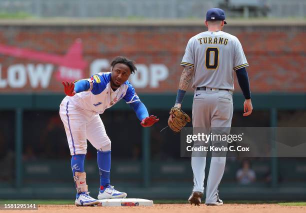 Ozzie Albies of the Atlanta Braves reacts after hitting a double in the eighth inning against the Milwaukee Brewers at Truist Park on July 30, 2023...