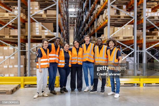 portrait of multi-ethnic warehouse workers standing together - warehouse worker stock pictures, royalty-free photos & images