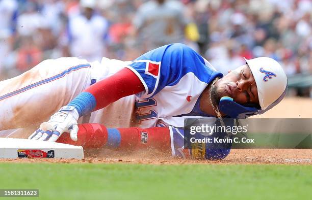 Orlando Arcia of the Atlanta Braves reacts after he istagged out at third base by Andruw Monasterio of the Milwaukee Brewers on a single by Michael...