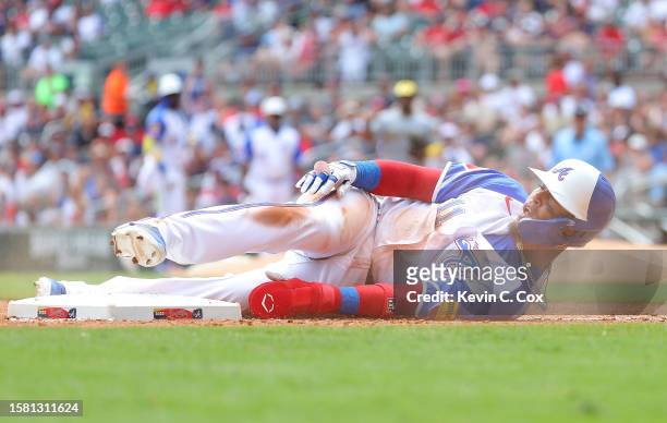 Orlando Arcia of the Atlanta Braves reacts after he istagged out at third base by Andruw Monasterio of the Milwaukee Brewers on a single by Michael...