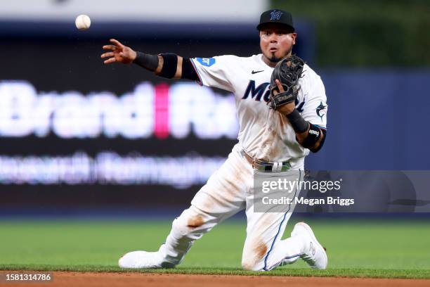 Luis Arraez of the Miami Marlins throws to first base for an out against the Detroit Tigers during the fifth inning at loanDepot park on July 30,...