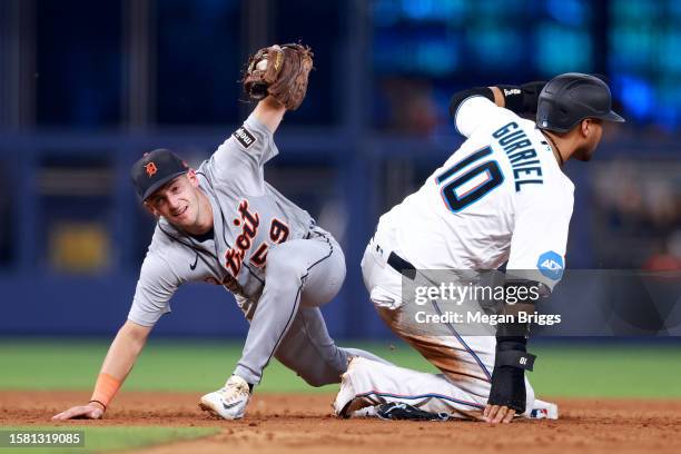 Yuli Gurriel of the Miami Marlins slides safe to second base against Zack Short of the Detroit Tigers during the sixth inning at loanDepot park on...