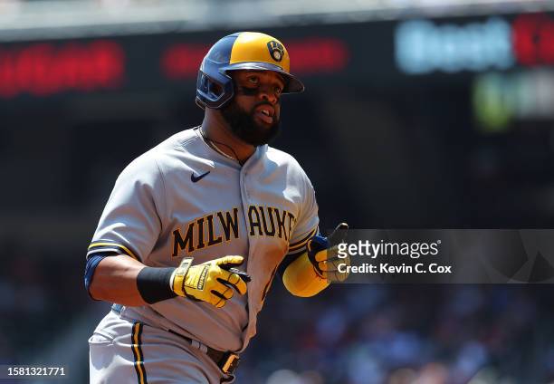 Carlos Santana of the Milwaukee Brewers reacts as he rounds third baseafter hitting a solo homer in the third inning against the Atlanta Braves at...