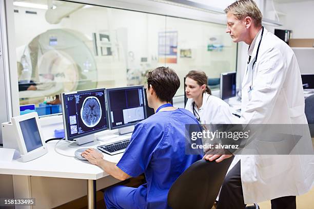 doctors at a computer tomography exam - cat scan 個照片及圖片檔