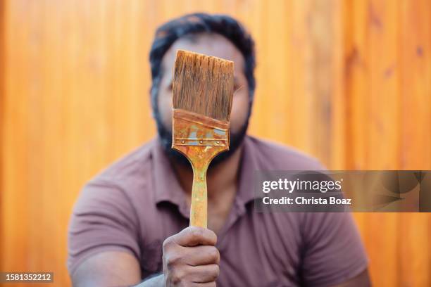 east indian man with paintbrush - christa stock pictures, royalty-free photos & images