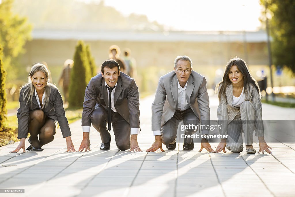 Businesspeople on a starting line, ready to run