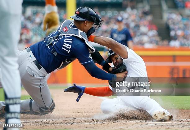Andy Ibanez of the Detroit Tigers is tagged out by catcher Christian Bethancourt of the Tampa Bay Rays trying to score during the second inning at...