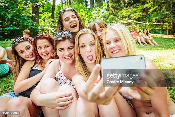 girls together summer camp snapshot - blonde girl sticking out her tongue stock pictures, royalty-free photos & images