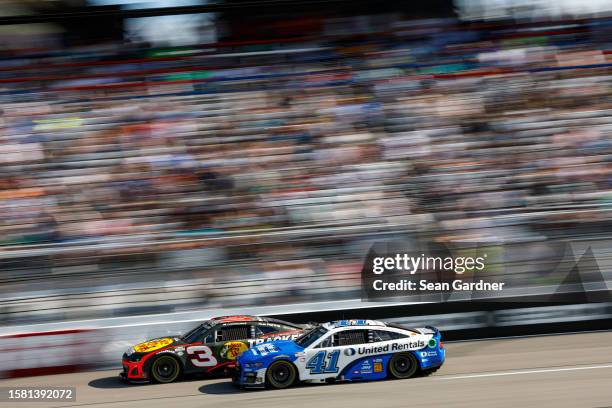 Austin Dillon, driver of the Bass Pro Shops Club Chevrolet, and Ryan Preece, driver of the United Rentals Ford, race during the NASCAR Cup Series...