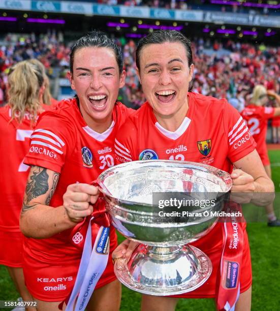 Dublin , Ireland - 6 August 2022; Cork players, Ashling Thompson, left, and Hannah Looney celebrate with O'Duffy Cup after their side's victory in...