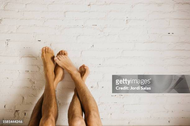 men's cross-legged on a white wall - crush foot stock pictures, royalty-free photos & images