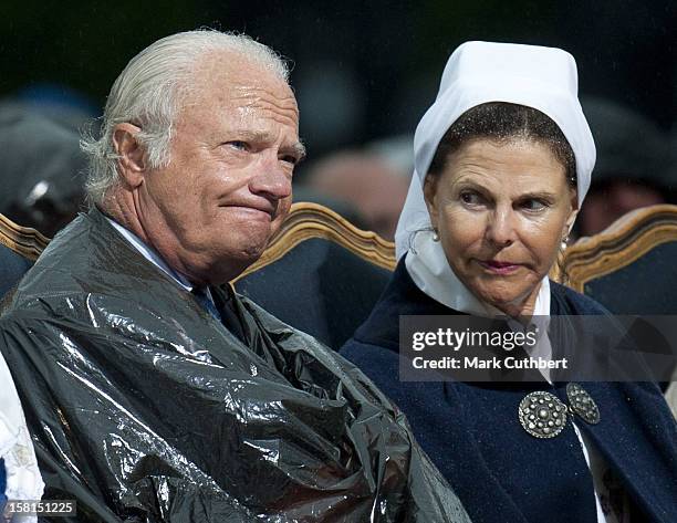 King Carl Xvi Gustaf Of Sweden And Queen Silvia Of Sweden Use Binliners To Keep Themselves Dry During Princess Victoria Of Sweden'S 34Th Birthday...