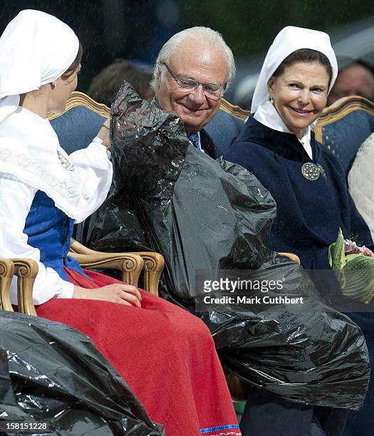 Princess Victoria, King Carl Xvi Gustaf Of Sweden Queen Silvia Of Sweden And Princess Madeleine Use Binliners To Keep Themselves Dry During Princess...