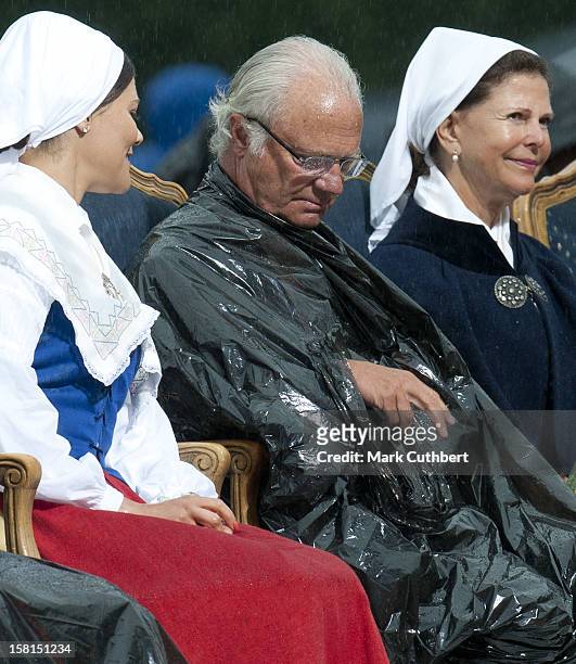Princess Victoria, King Carl Xvi Gustaf Of Sweden And Queen Silvia Of Sweden Use Binliners To Keep Themselves Dry During Princess Victoria Of...
