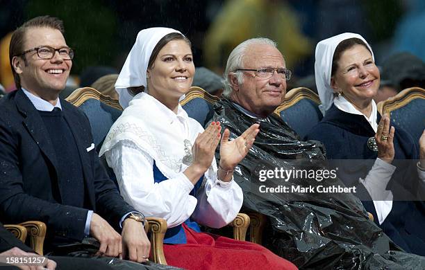 Prince Daniel, Princess Victoria, King Carl Xvi Gustaf Of Sweden And Queen Silvia Of Sweden Use Binliners To Keep Themselves Dry During Princess...