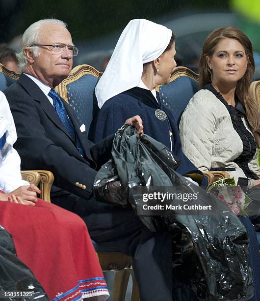 King Carl Xvi Gustaf Of Sweden And Queen Silvia Of Sweden Use Binliners To Keep Themselves Dry During Princess Victoria Of Sweden'S 34Th Birthday...