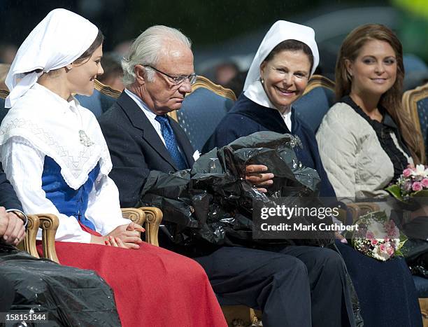 Princess Victoria, King Carl Xvi Gustaf Of Sweden, Queen Silvia Of Sweden And Princess Madeleine Of Sweden Use Binliners To Keep Themselves Dry...