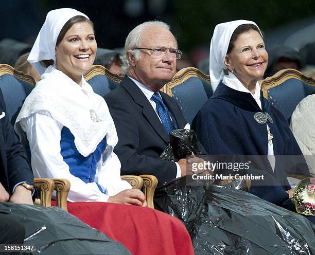 Princess Victoria Of Sweden, King Carl Xvi Gustaf Of Sweden And Queen Silvia Of Sweden Use Binliners To Keep Themselves Dry During Princess Victoria...
