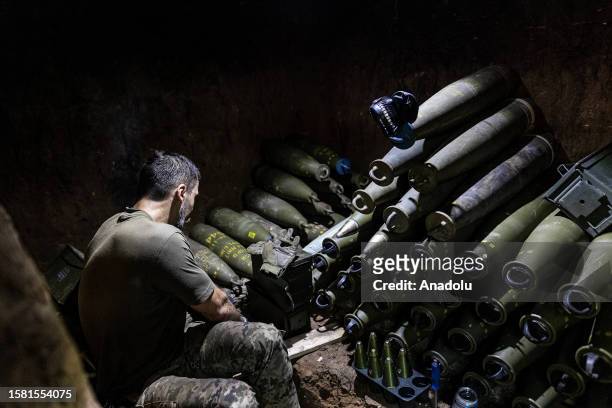 Ukrainian soldier prepares 155mm artillery shells in his fighting position as Ukrainian Army conduct operation to target trenches of Russian forces...